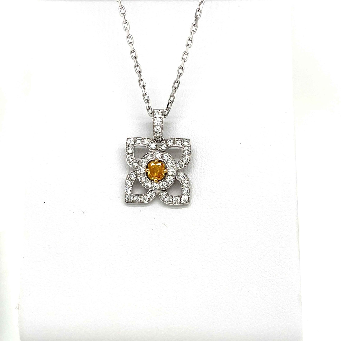 18 Karat White Gold Flower Pendant with a Natural Orange Yellow Radiant Center Diamond and Fine White Round Diamond Accents
