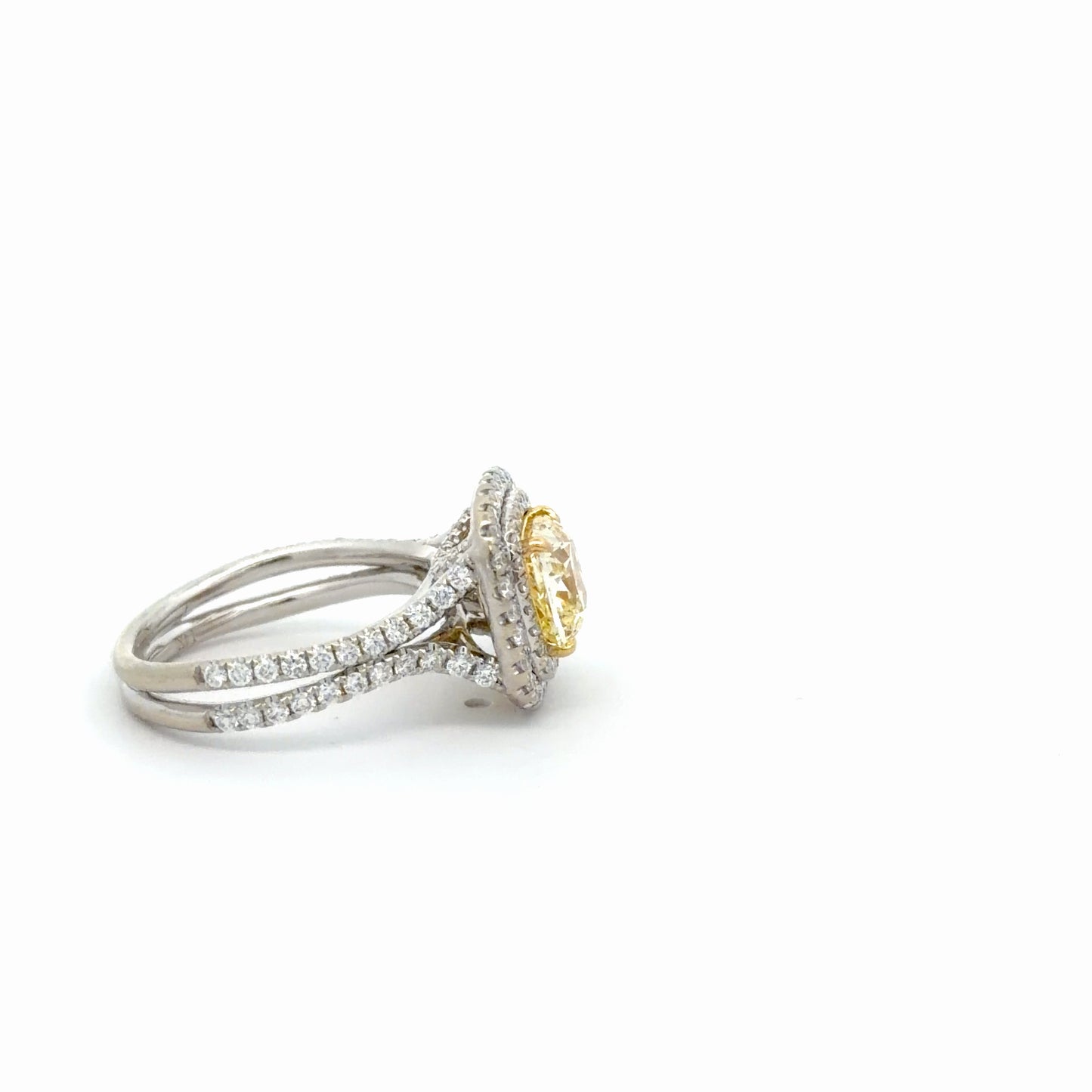 Double Halo Ring in 14kt. White Gold with 2 carat Natural Mined GIA Fancy Light Yellow Cushion with Round Diamonds on the band.