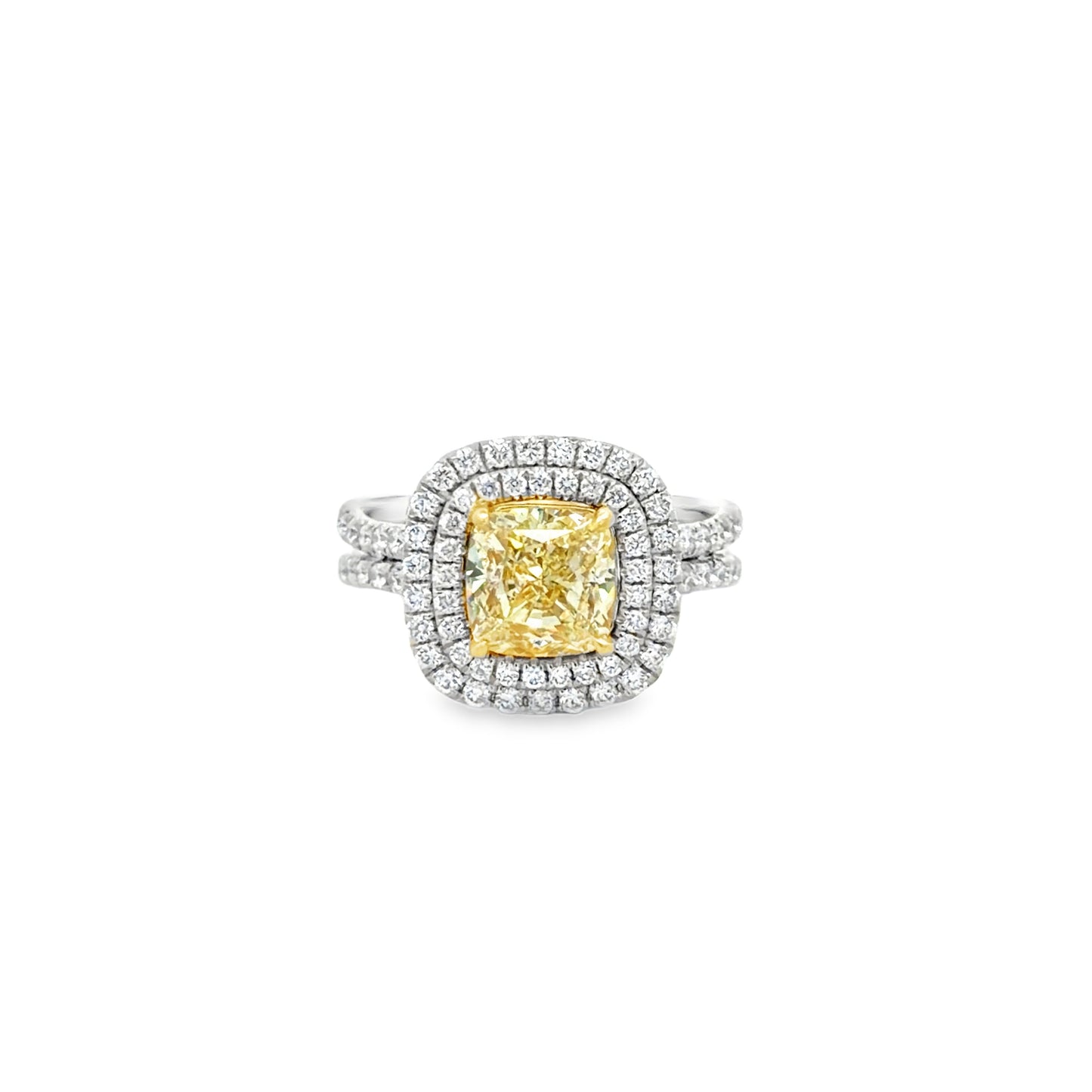 Double Halo Ring in 14kt. White Gold with 2 carat Natural Mined GIA Fancy Light Yellow Cushion with Round Diamonds on the band.