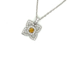 18 Karat White Gold Flower Pendant with a Natural Orange Yellow Radiant Center Diamond and Fine White Round Diamond Accents - FlawlessCarat